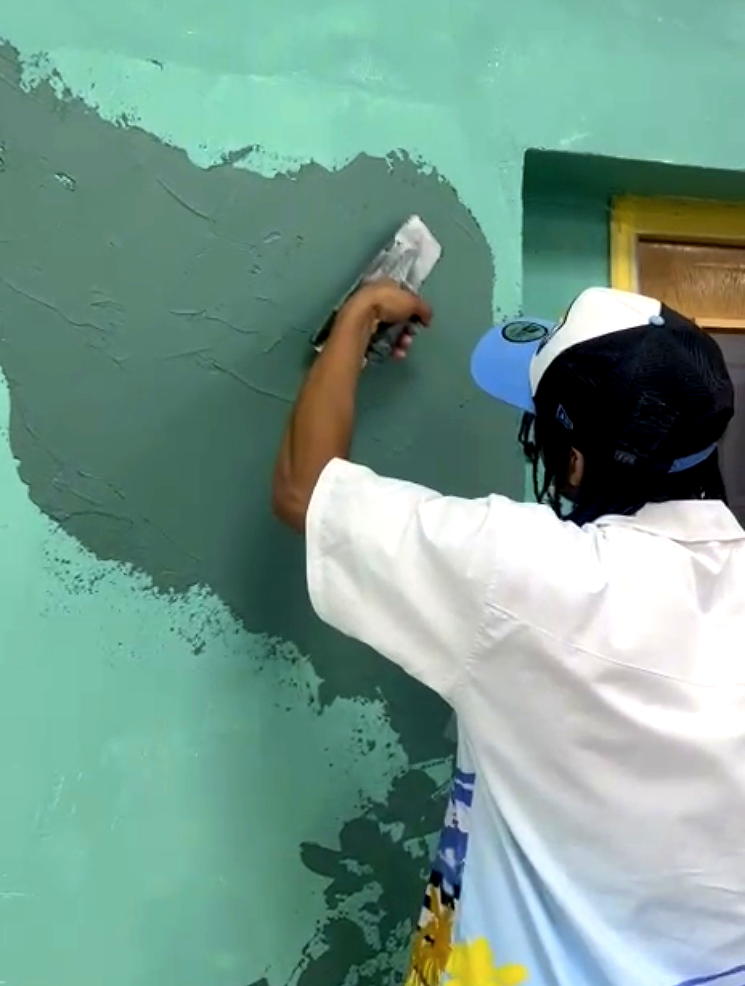 Kyro troweling a jade green plaster finish